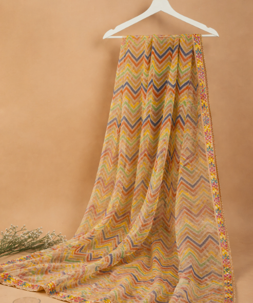 Close-up of multicolor chevron print on beige dupatta with gold floral lace border
