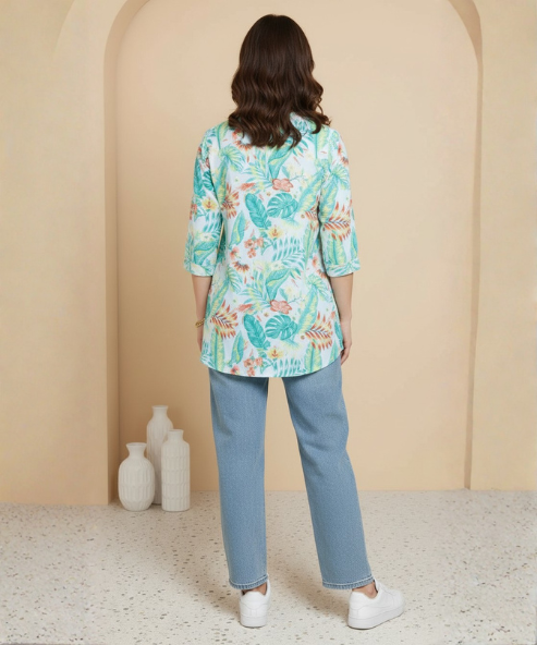 Woman wearing mint green tropical floral print tunic with mandarin collar and three-quarter sleeves