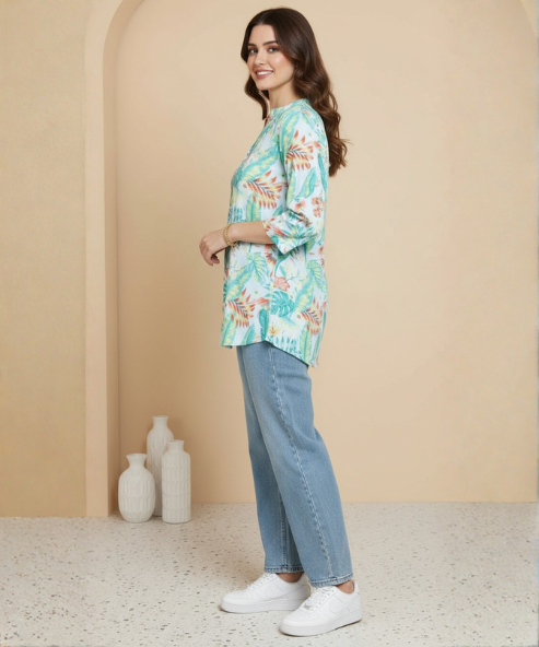 Woman wearing mint green tropical floral print tunic with mandarin collar and three-quarter sleeves